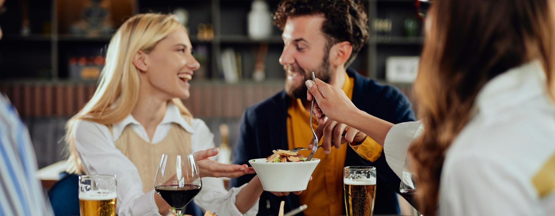a group of people eating at a restaurant