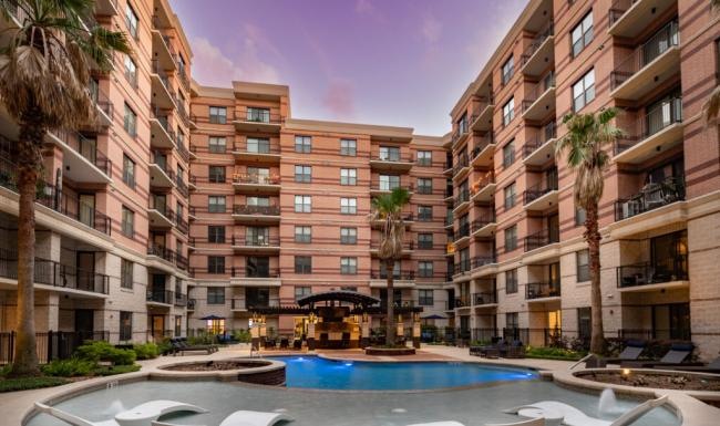 a pool in a courtyard between buildings