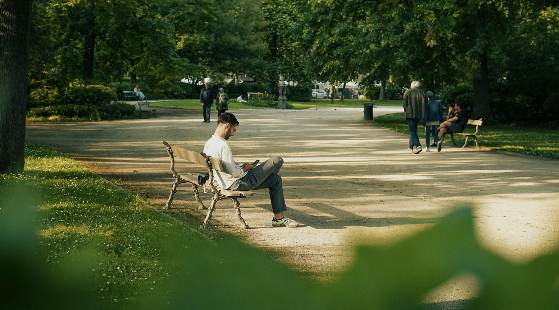 a man sitting on a bench in  Buffalo Bayou Park near Memorial Hills
